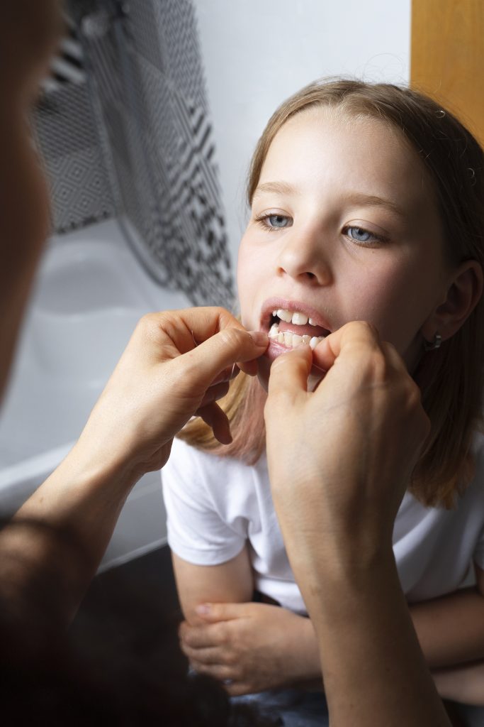 person taking care teeth hygiene